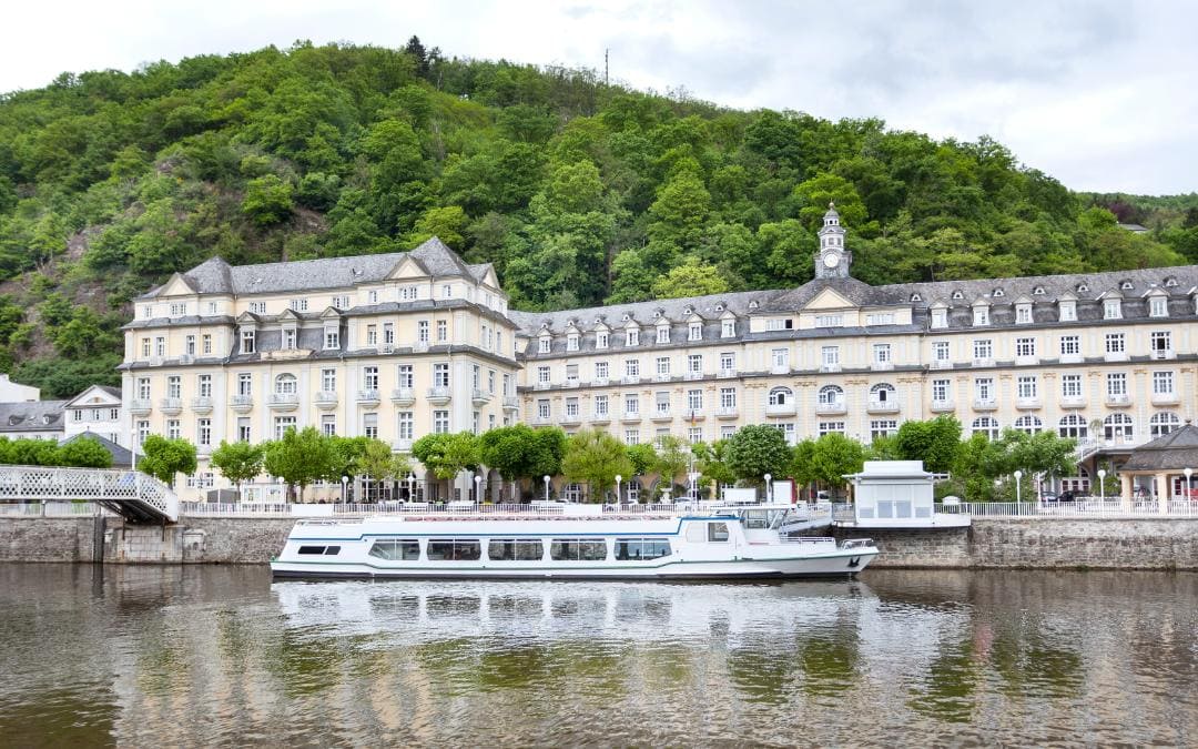 Kurhaus Bad Ems, Rhineland-Palatinate - Exterior view of the building on the Lahn, in the foreground the Lahn and a passenger ship