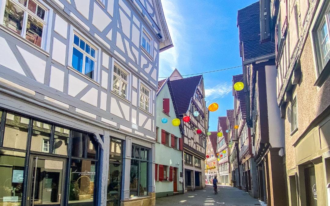 Old Town Herrenberg - colorful balloons strung on strings span the alley between the half-timbered houses - angiestravelroutes.com