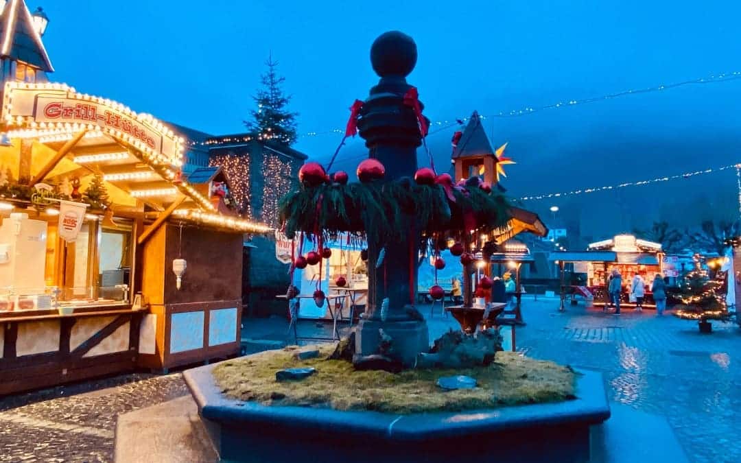 Cochem - Christmas market on Endertplatz - the fountain is decorated with an Advent wreath with red baubles - angiestravelroutes.com