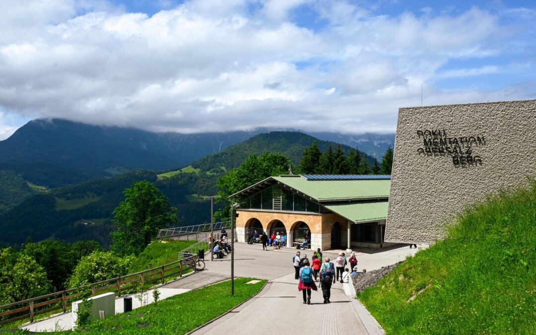 Berchtesgaden - Dokumentation Obersalzberg - View from the footpath of the old building (left) and the new building (right, with the lettering "DOKUMENTATION OBERSALZBERG"), with the mountains behind, somewhat overcast - angiestravelroutes.com