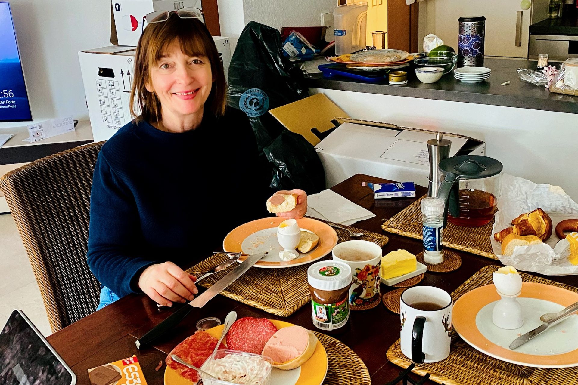 bb-annual-review-2025-angelika-klein bb monthly review January 2025 - me at the breakfast table in my new apartment, moving boxes in the background - angiestravelroutes.com