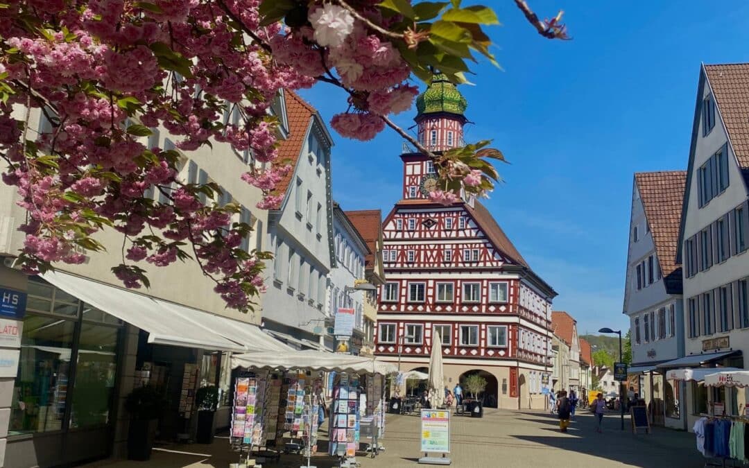 View from Kirchheim's Marktstraße (pedestrian zone with stores and cafés) of the half-timbered town hall with its curved tower dome - angiestravelroutes.com