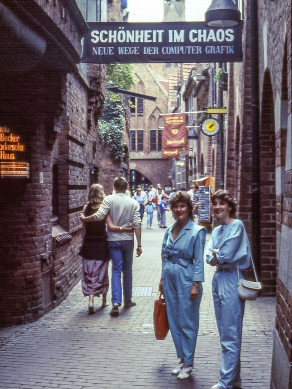 Bremen, Böttcherstraße, ca 1990 - my mother and I, both in light blue, standing under a banner with the inscription "u0022Beauty in Chaos" - angiestravelroutes.com