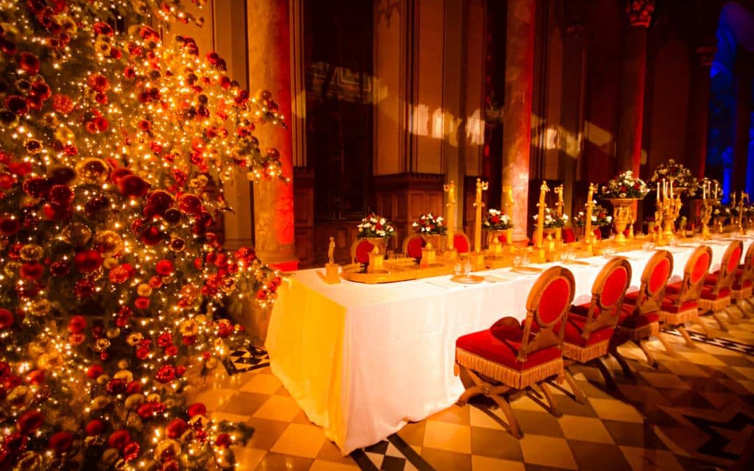 Hohenzollern Castle, Count's Hall - the opulently decorated festive table, in the foreground part of the Christmas tree adorned with red and gold baubles - angiestravelroutes.com