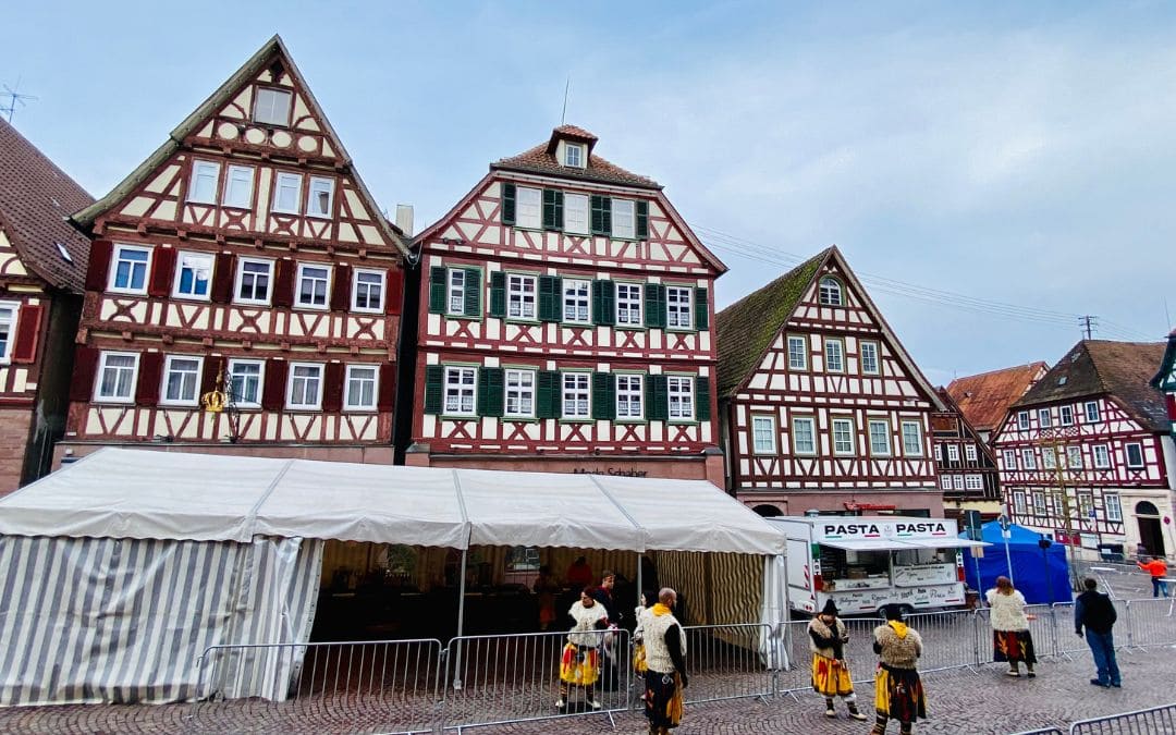 Calw market square - three half-timbered houses, in the center Hermann Hesse's birthplace - in front of the houses a beer tent and a food truck with the sign "Pasta Pasta" - angiestravelroutes.com