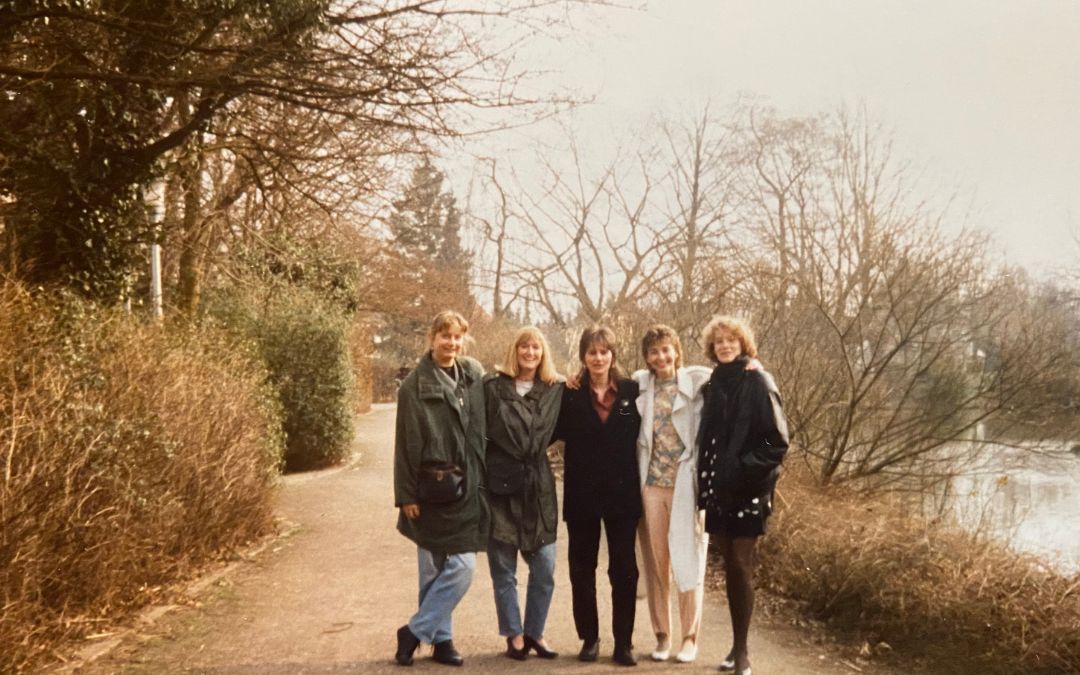 Delmenhorst, Graftwiesen, March 1992 - me (with a long white coat) with 4 friends in a row, we have our arms around each other's shoulders and are all looking happily into the camera - the vegetation in the city park is still wintry with lots of undergrowth and little foliage - angiestravelroutes.com