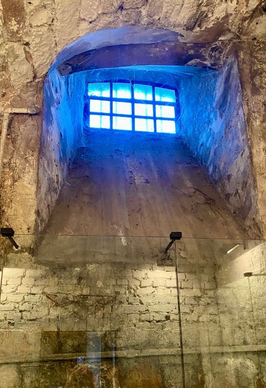 Former Gestapo detention cell with a barred window in the dungeon beneath Saarbrücken Castle