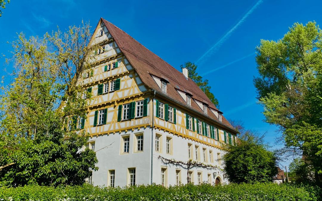 View of the former Dominican convent in Kirchheim - the lower two floors are brightly plastered, above them 5 floors of yellow-painted half-timbering up to the roof gable - angiestravelroutes.com