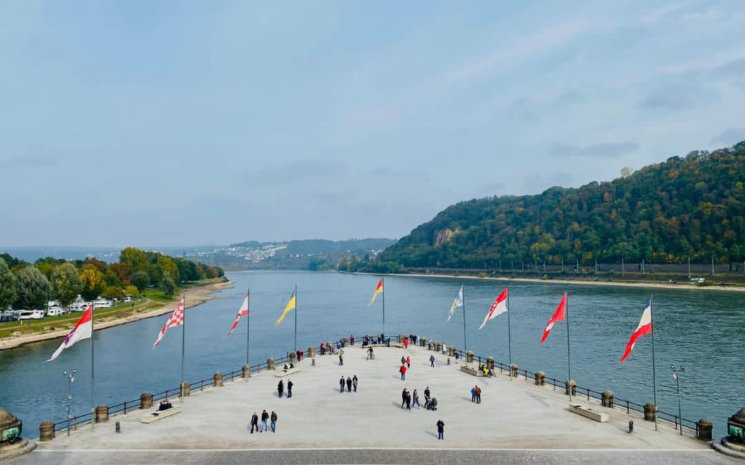 Koblenz Attractions: The promontory of the Deutsches Eck, with the flags of the federal states, as seen from the steps of the Kaiser Wilhelm statue