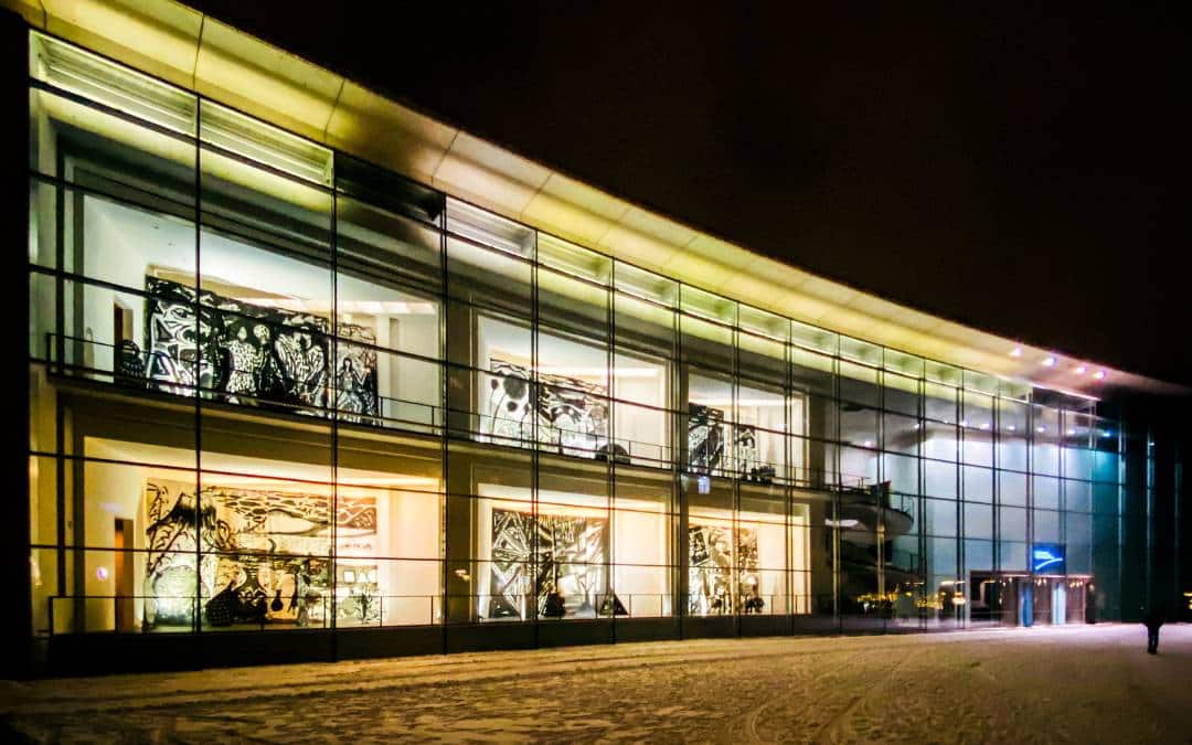 Neues Museum, Nuremberg - photographed on a winter's night - the large-format black and white artworks on display can be seen through the brightly lit windows of the building - angiestravelroutes.com 