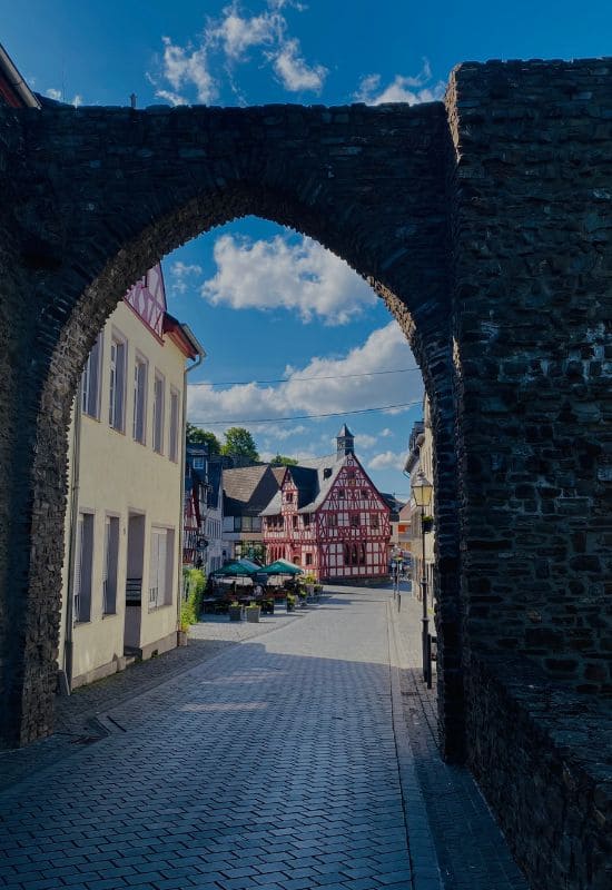 View through the medieval city gate toward the Old Town Hall in Rhens