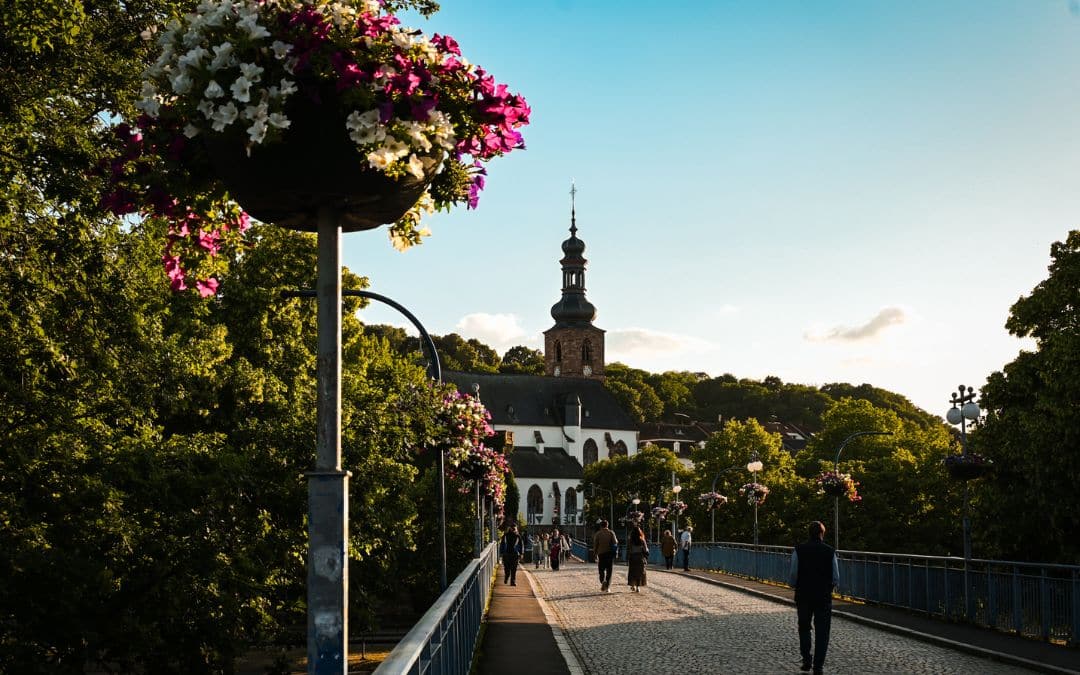 The Old Bridge in Saarbrücken, decorated with flowers, with the Schlosskirche in the background