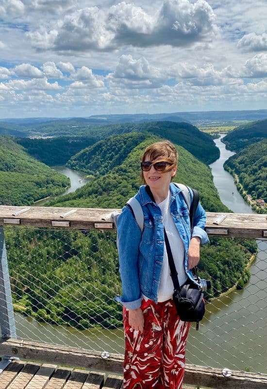 Angelika on the observation tower of the treetop trail, with the Saar Loop in the background