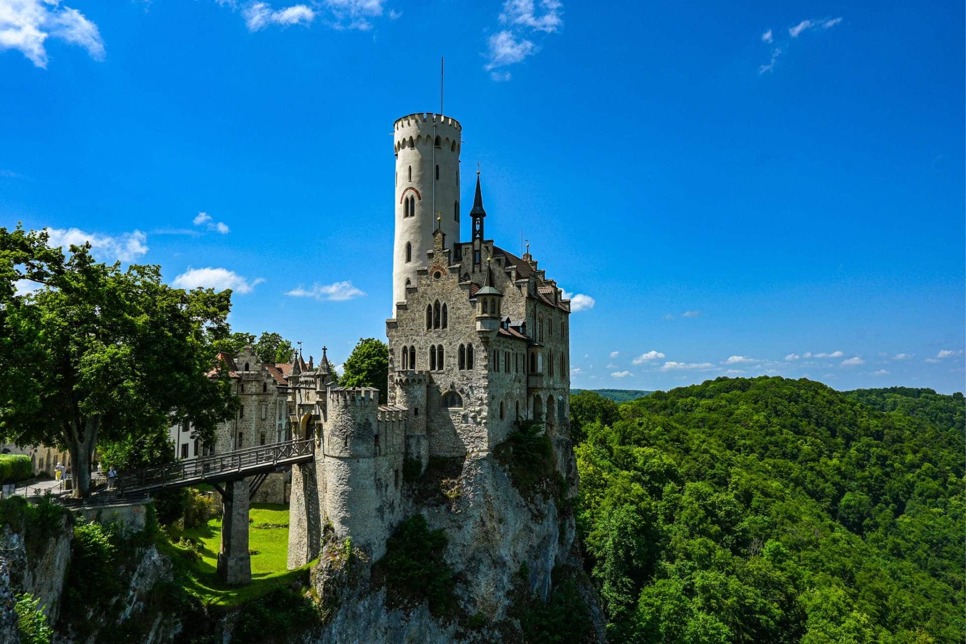 Lichtenstein Castle, Swabian Alb, Württemberg, Reutlingen district: The neo-Gothic core castle with almost white tower on a rock, photographed from the vantage point within the castle grounds - angiestravelroutes.com