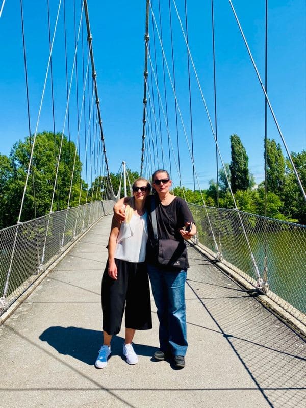 Max-Eyth-See, Max-Eyth-Steg (Golden Gatele), Stuttgart - I am standing with my daughter on an iron bridge, in the background the Neckar river and the vineyards - angiestravelroutes.com