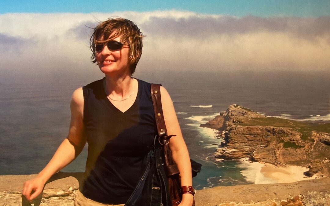 South Africa, Cape of Good Hope, 2005 - Angelika (with sunglasses and windblown hair) at the viewpoint of the Cape of Good Hope, with the Atlantic Ocean in the background, the Cape in the right background - angiestravelroutes.com