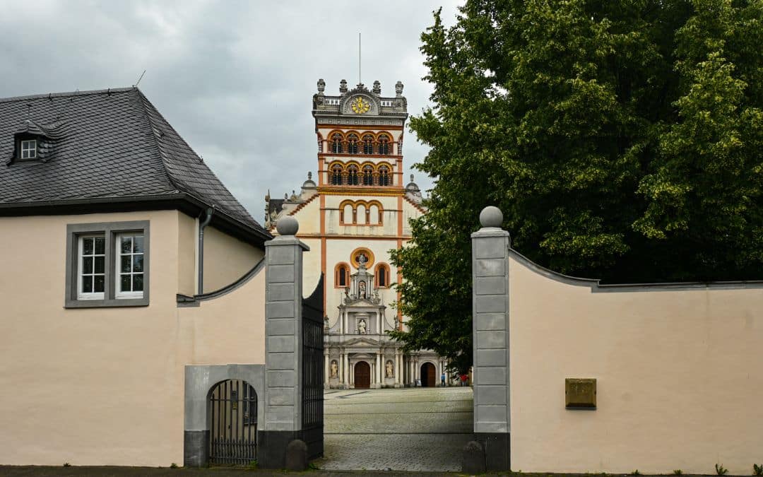 View through an open wrought-iron gate in a plastered wall toward St. Matthias Basilica