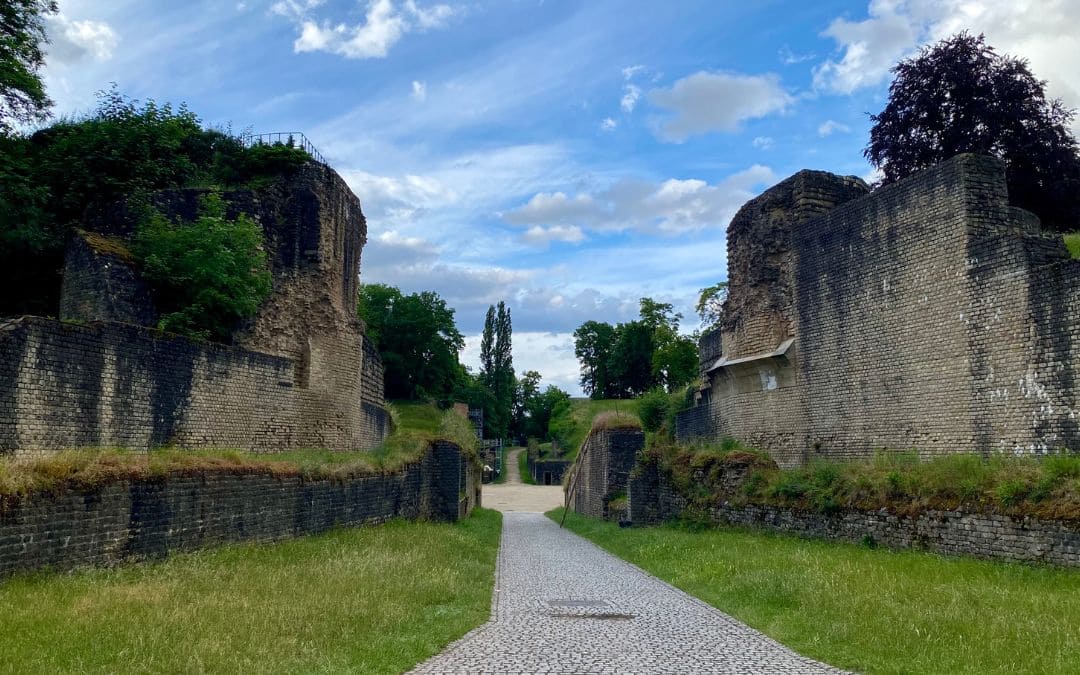Weg zwischen hohen römischen Mauern zum Amphitheater in Trier
