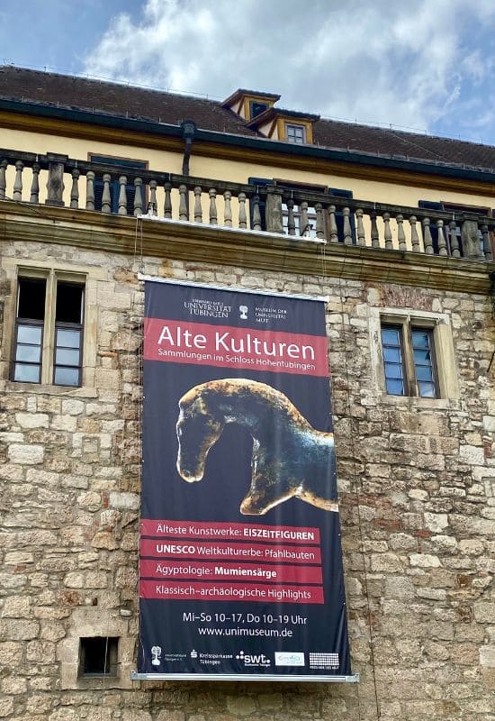 Außenmauer von Schloss Hohentübingen: Transparent zum Museum Alte Kulturen mit Foto des Urzeit-Pferds aus der Vogelherdhöhle
