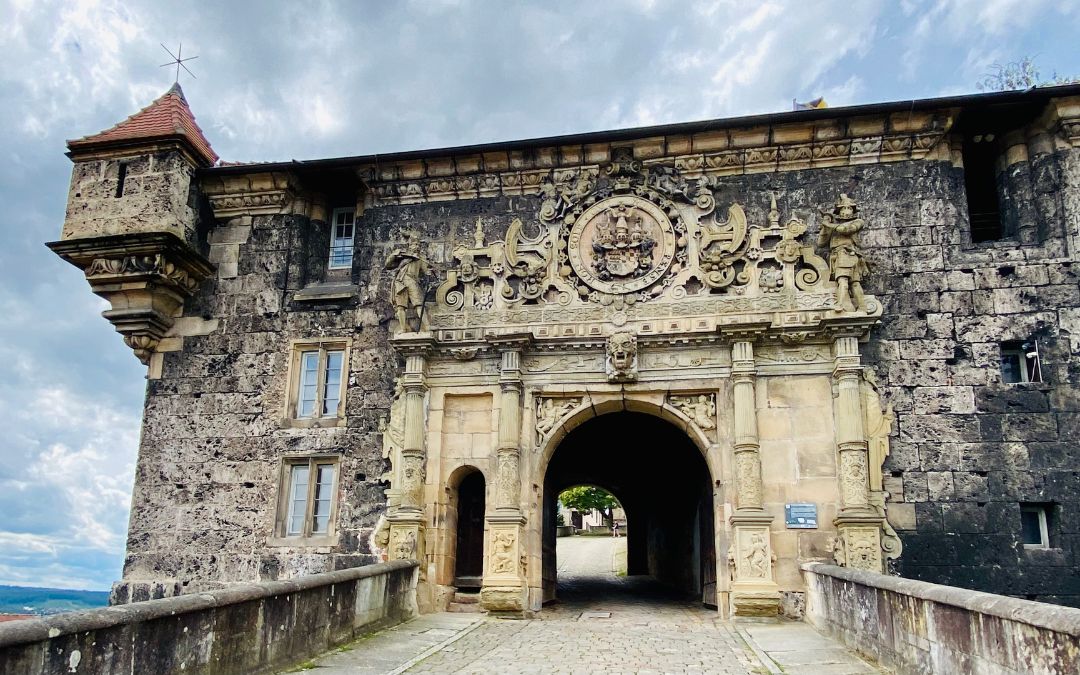 Tübingen, Hohentübingen Palace, Lower Palace Gate - sandstone in the shape of a Roman triumphal arch, lavishly decorated - the coat of arms of the Duchy of Württemberg is carved at the top, framed by medal chains - angiestravelroutes.com