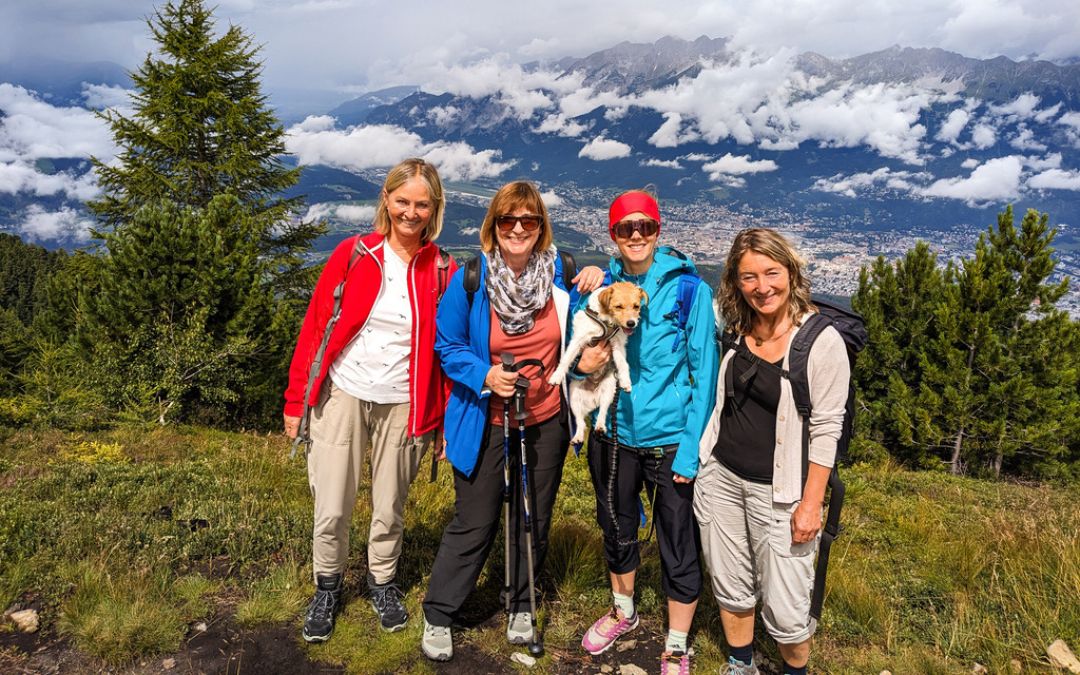 Wir vier posieren mit Cookie am Zirbenweg mit Ausblick auf Innsbruck - angiestravelroutes.com